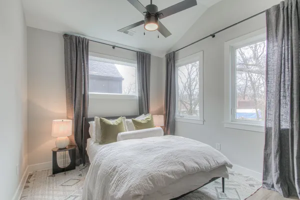 a bedroom with a bed and a window