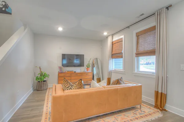 a living room with furniture and a potted plant