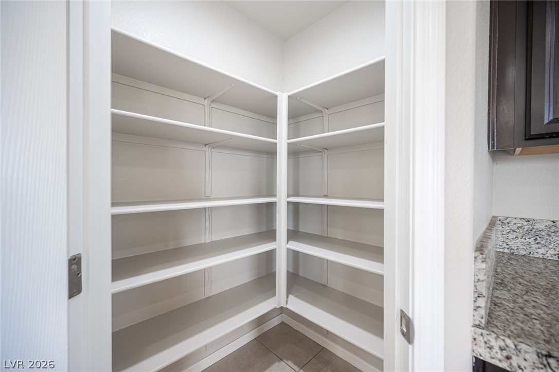 9916 Sable Point Street Las Vegas, NV 89178 - Photo 39 of 73 Ample built-in shelving provides abundant storage for all kitchen essentials.