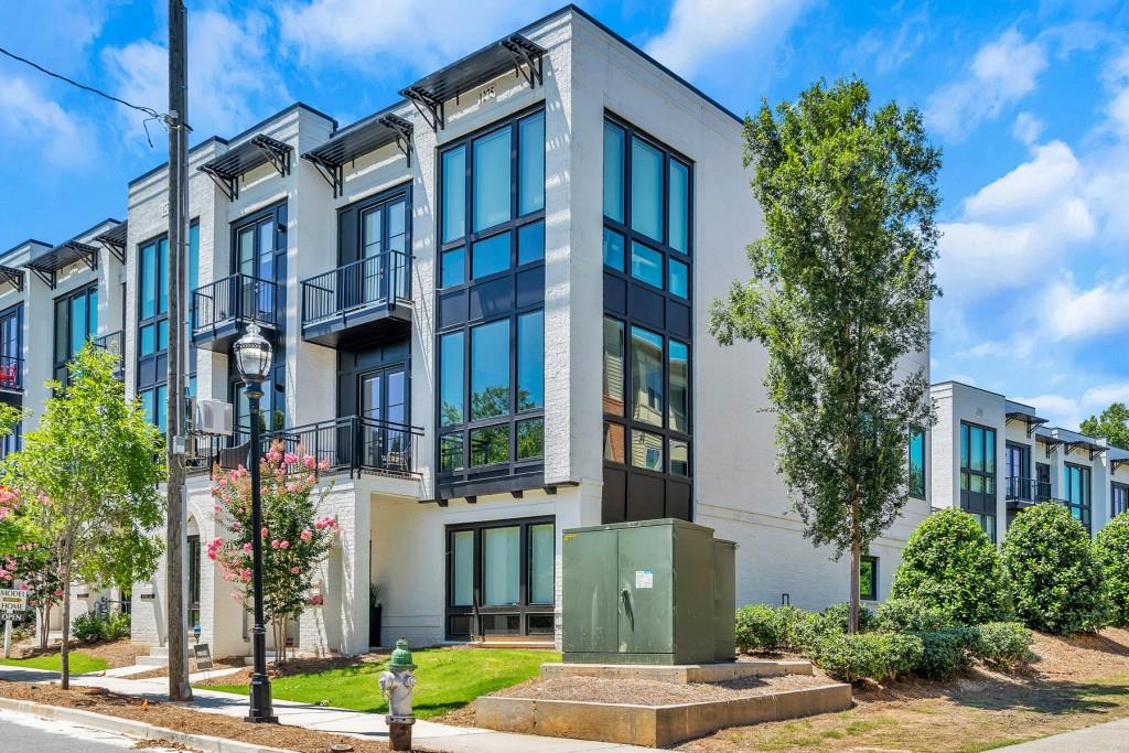 a front view of a multi story building with yard
