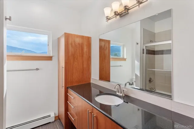 a bathroom with a shower and a bath tub