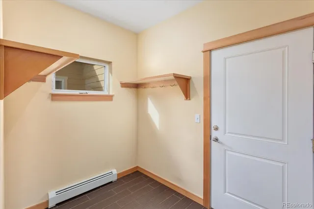 an empty room with a window and a ceiling fan