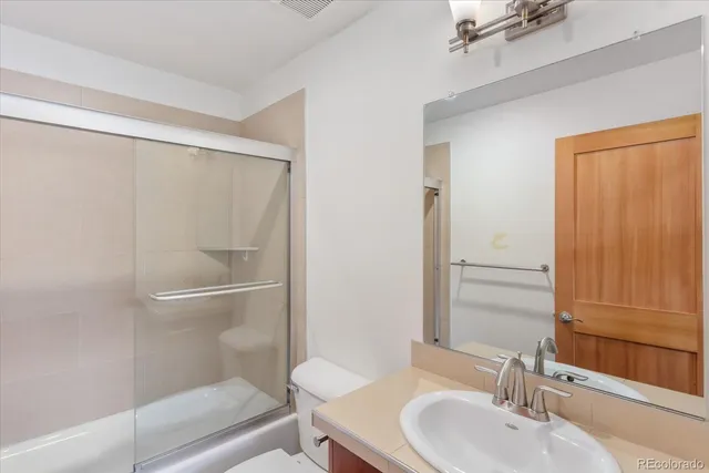 a view of a livingroom with a ceiling fan and window