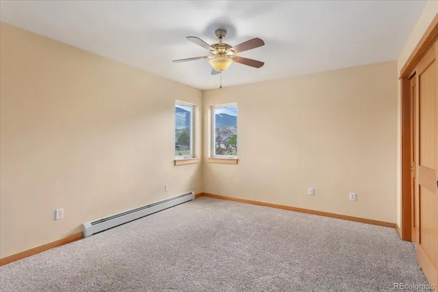 an empty room with chandelier fan