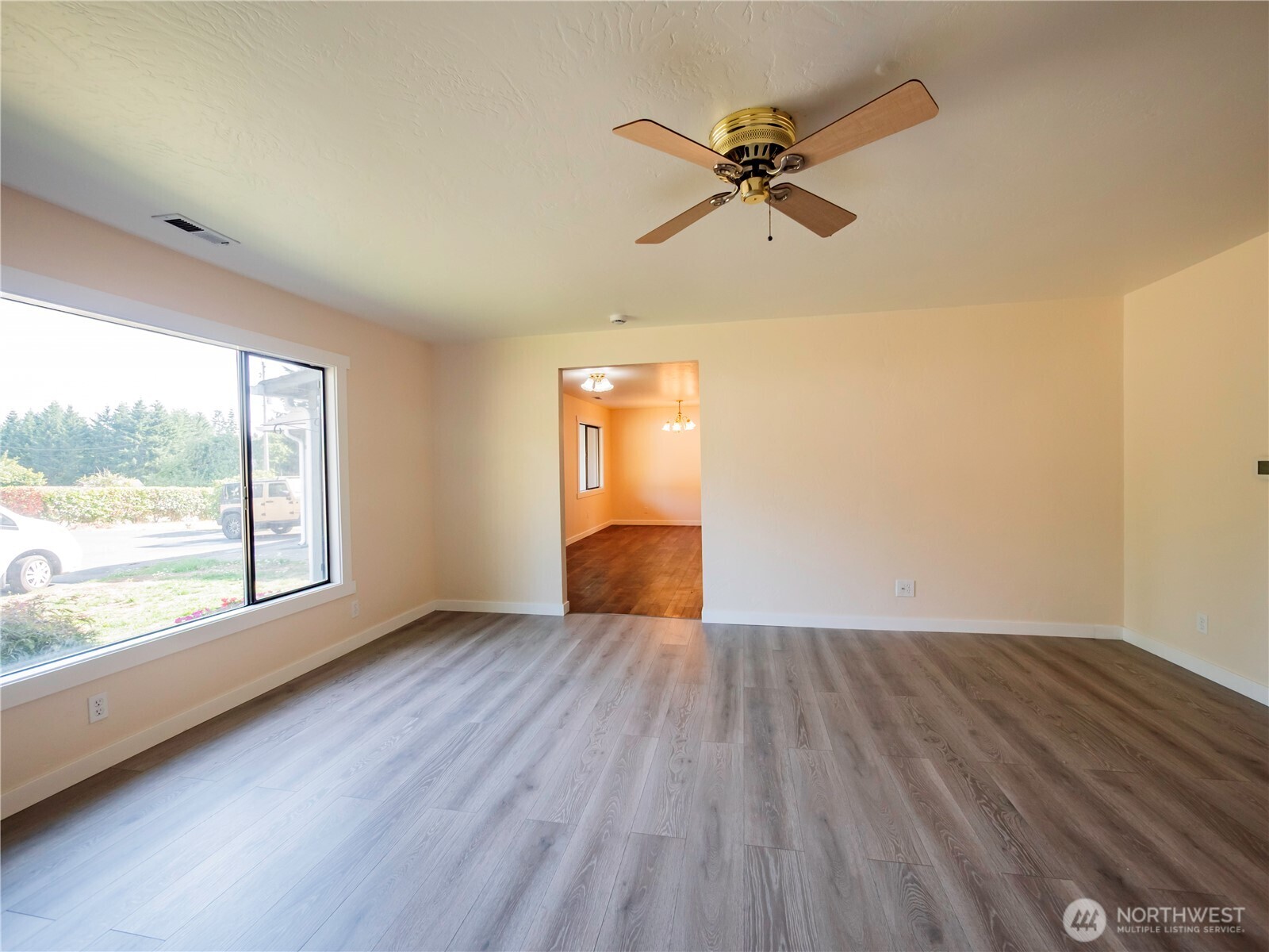 500 Mill Creek Road Southeast Shelton, WA 98584 - Photo 18 of 39 an empty room with wooden floor fan and windows