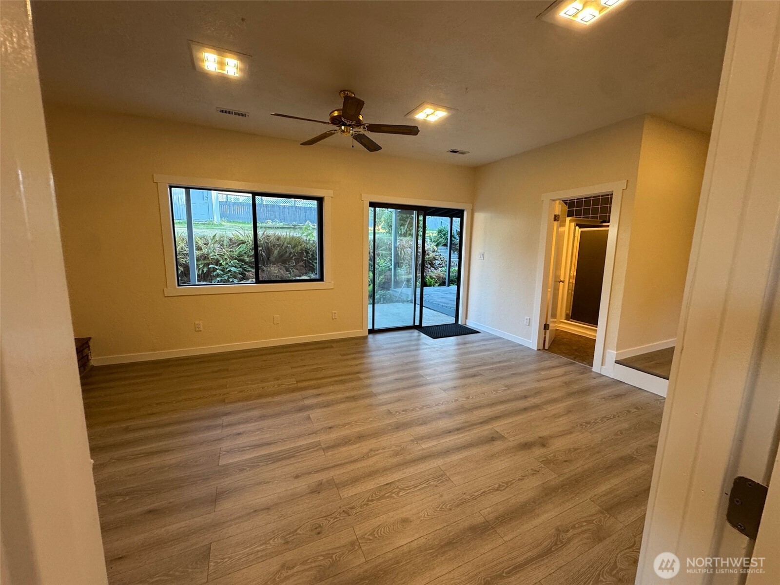 500 Mill Creek Road Southeast Shelton, WA 98584 - Photo 31 of 39 an empty room with wooden floor and windows