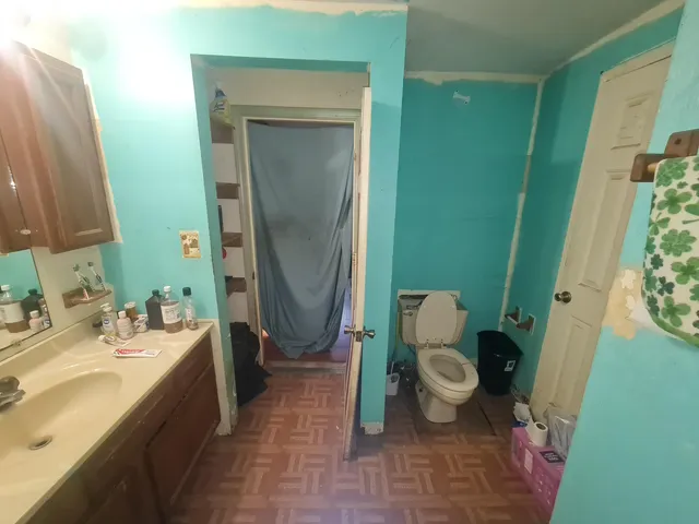 a bedroom with a bed and a mirror