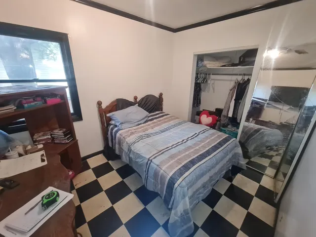 a bedroom with a bed and a flat screen tv