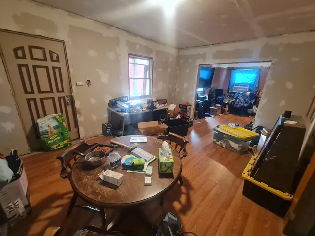 a view of a workspace with furniture and wooden floor