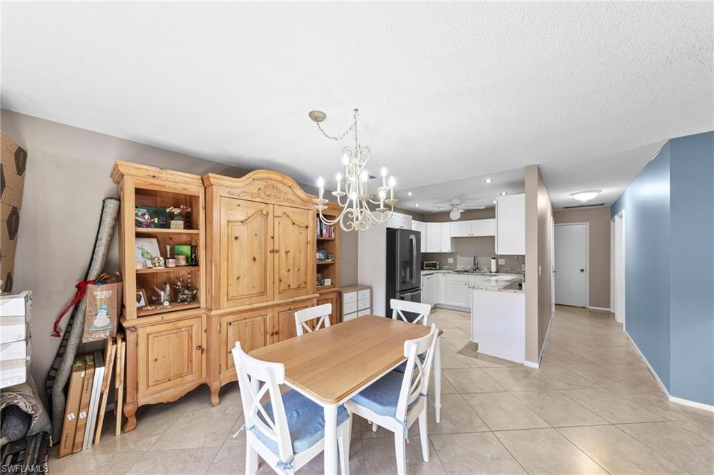 180 Harrison Road, Unit G4 Naples, FL 34112 - Photo 15 of 46 a kitchen with stainless steel appliances a refrigerator and microwave