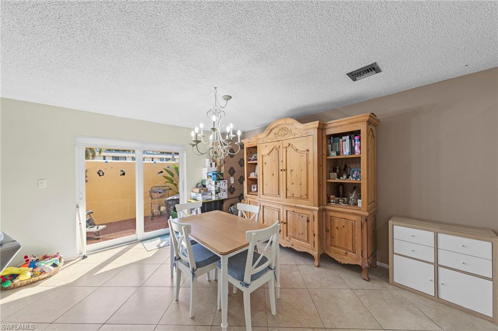 180 Harrison Road, Unit G4 Naples, FL 34112 - Photo 16 of 46 a dining room with furniture and window