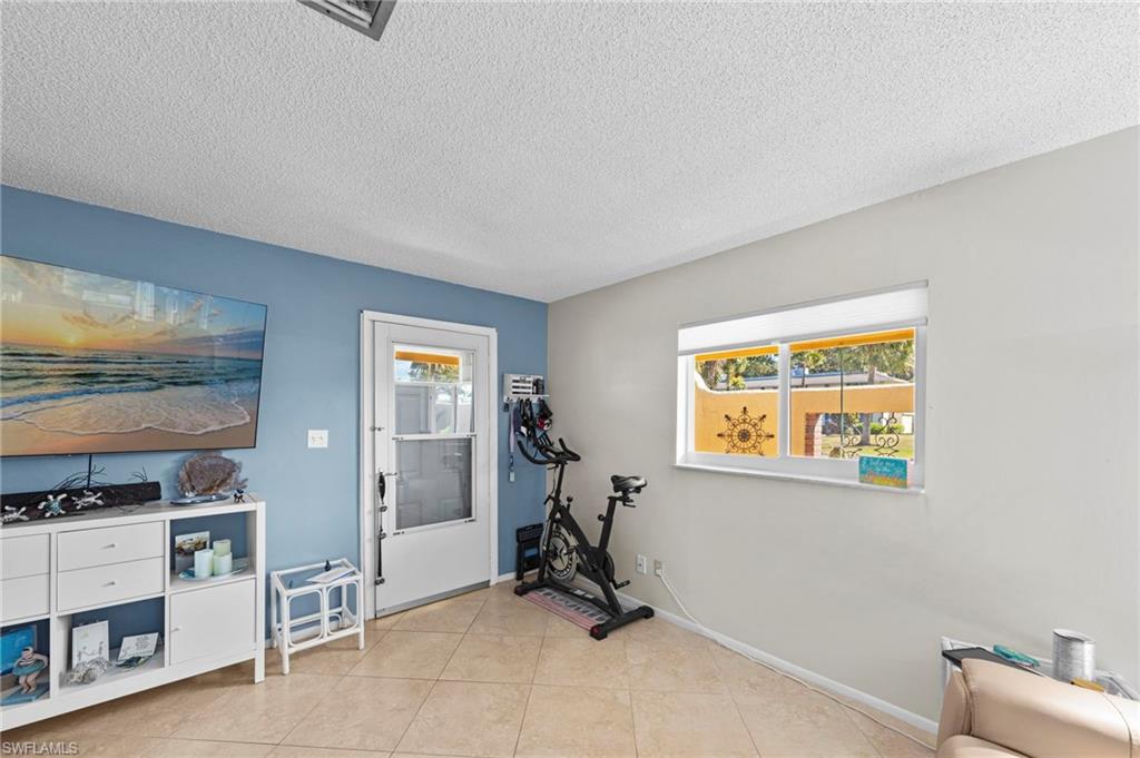 180 Harrison Road, Unit G4 Naples, FL 34112 - Photo 17 of 46 a view of room with furniture and windows
