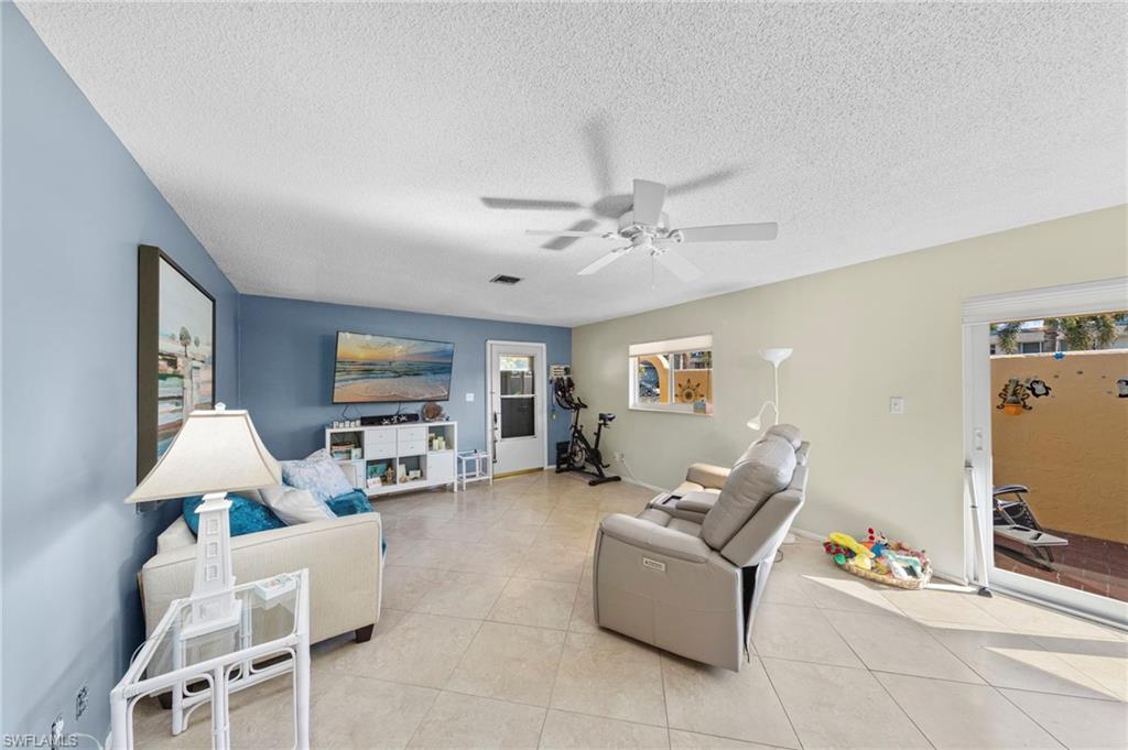 180 Harrison Road, Unit G4 Naples, FL 34112 - Photo 18 of 46 a living room with furniture and a flat screen tv