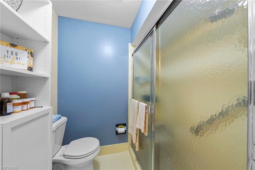 180 Harrison Road, Unit G4 Naples, FL 34112 - Photo 21 of 46 a bathroom with a toilet and a shower