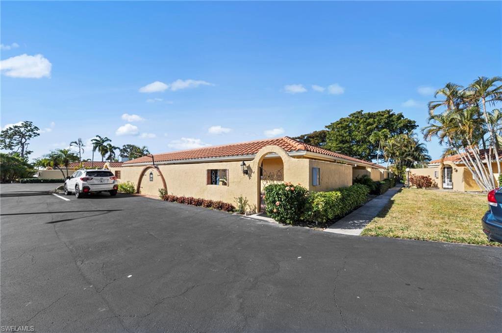 180 Harrison Road, Unit G4 Naples, FL 34112 - Photo 3 of 46 a view of a car parked on the side of a street