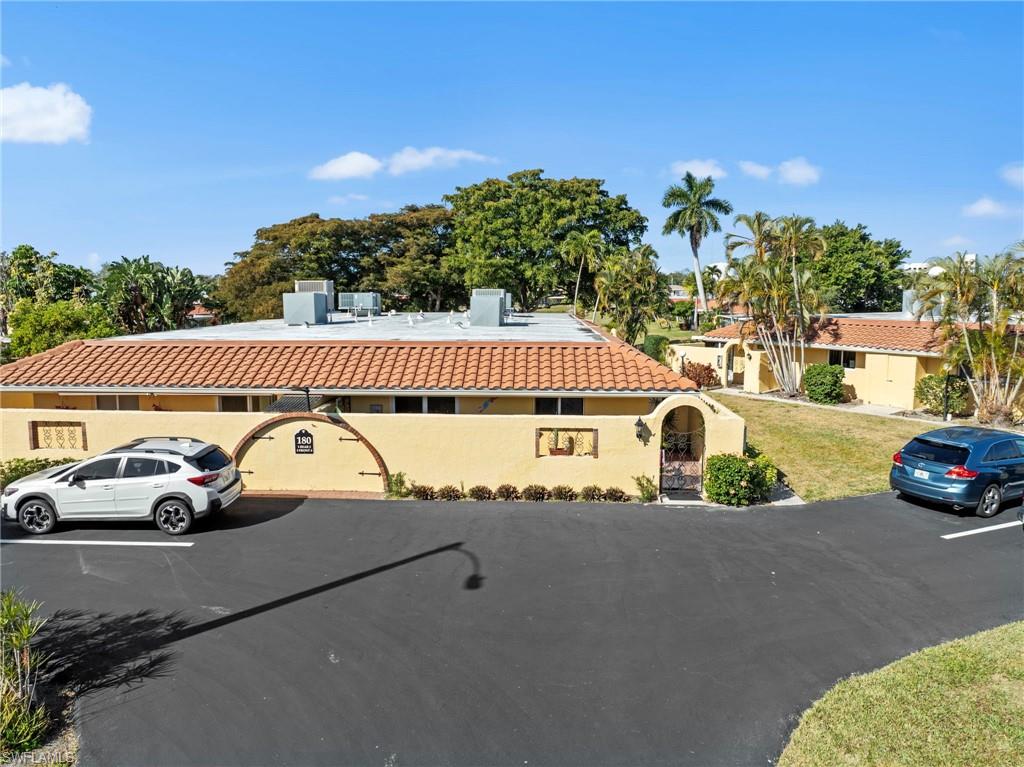 180 Harrison Road, Unit G4 Naples, FL 34112 - Photo 5 of 46 a view of street with parked cars