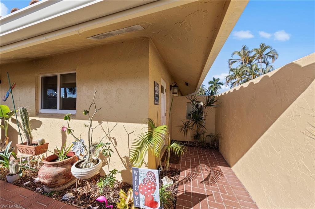 180 Harrison Road, Unit G4 Naples, FL 34112 - Photo 8 of 46 a view of a dining room filled with furniture and a potted plant