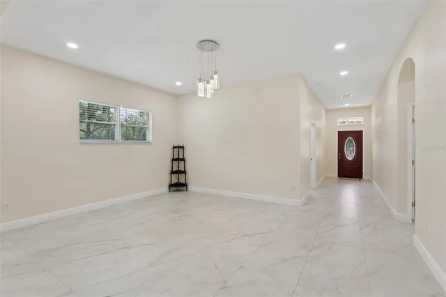 a kitchen with stainless steel appliances granite countertop a sink and a refrigerator