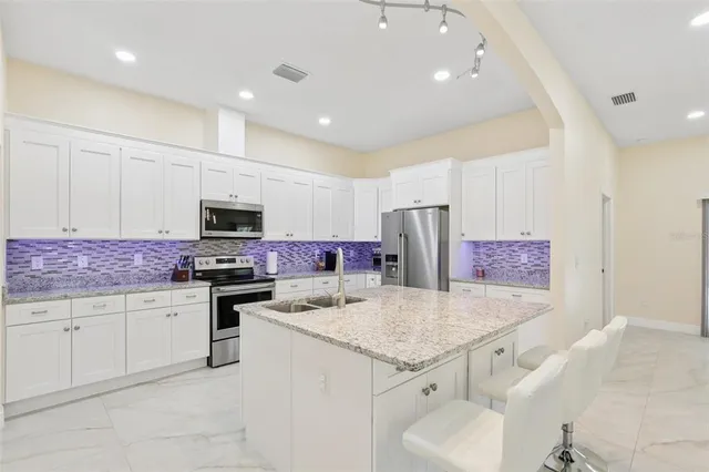 a bathroom with a granite countertop sink a mirror and a shower