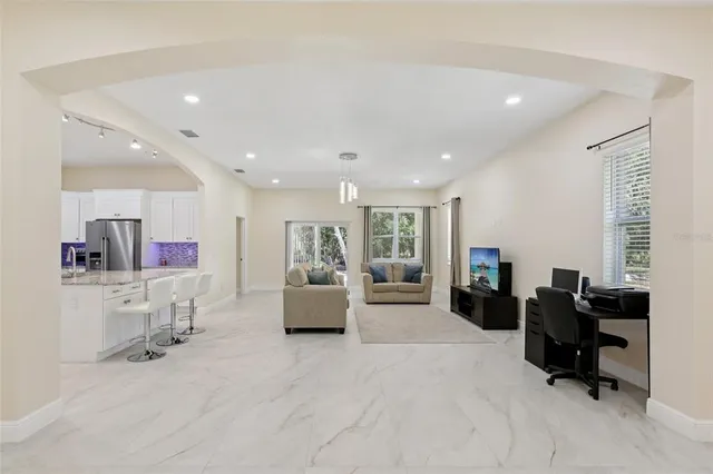 a living room with furniture and a large window