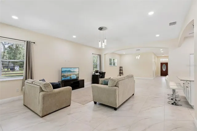 a living room with furniture and a large window