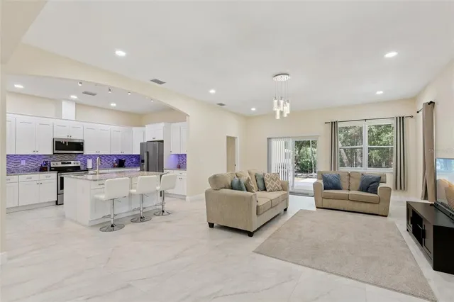a living room with furniture and a large window