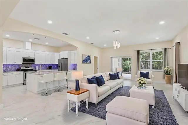 a living room with furniture and a chandelier