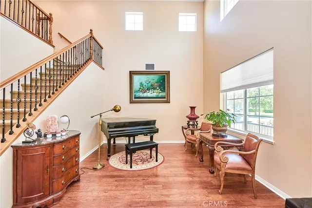 a dining room with furniture entryway and wooden floor