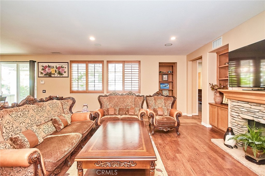 12430 Split Rein Drive Rancho Cucamonga, CA 91739 - Photo 16 of 29 a living room with furniture and a fireplace