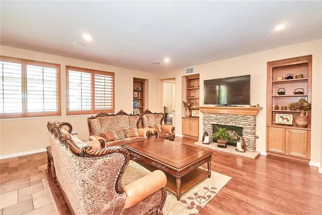 a living room with furniture a fireplace with wooden floor
