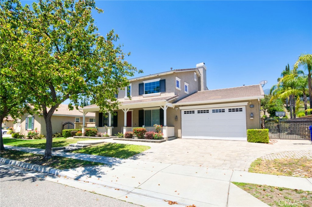 12430 Split Rein Drive Rancho Cucamonga, CA 91739 - Photo 2 of 29 a front view of a house with a yard and potted plants