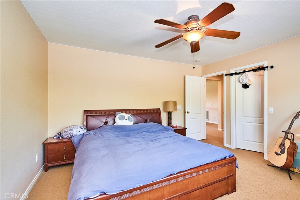 12430 Split Rein Drive Rancho Cucamonga, CA 91739 - Photo 21 of 29 a bedroom with a bed and a ceiling fan
