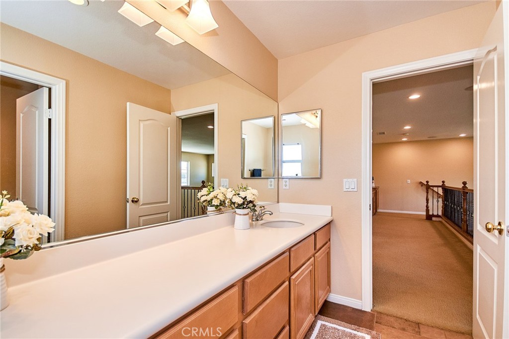 12430 Split Rein Drive Rancho Cucamonga, CA 91739 - Photo 25 of 29 a bathroom with a sink double vanity and a mirror