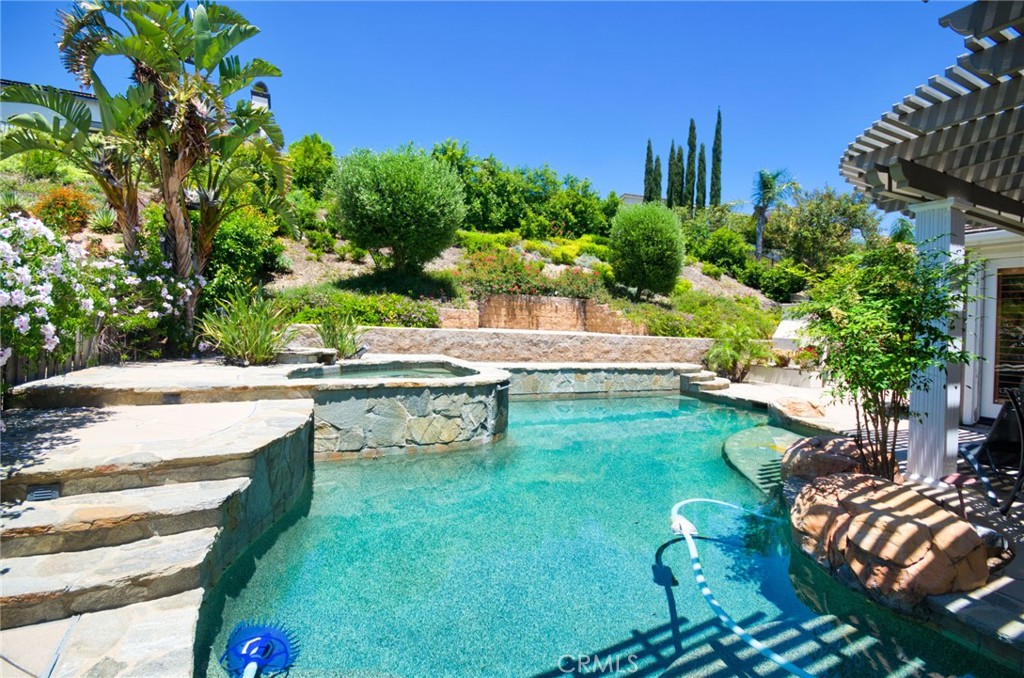 12430 Split Rein Drive Rancho Cucamonga, CA 91739 - Photo 10 of 29 a view of swimming pool with lawn chairs plants and large trees
