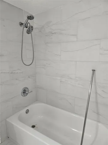 a bathroom with a bath tub and a shower