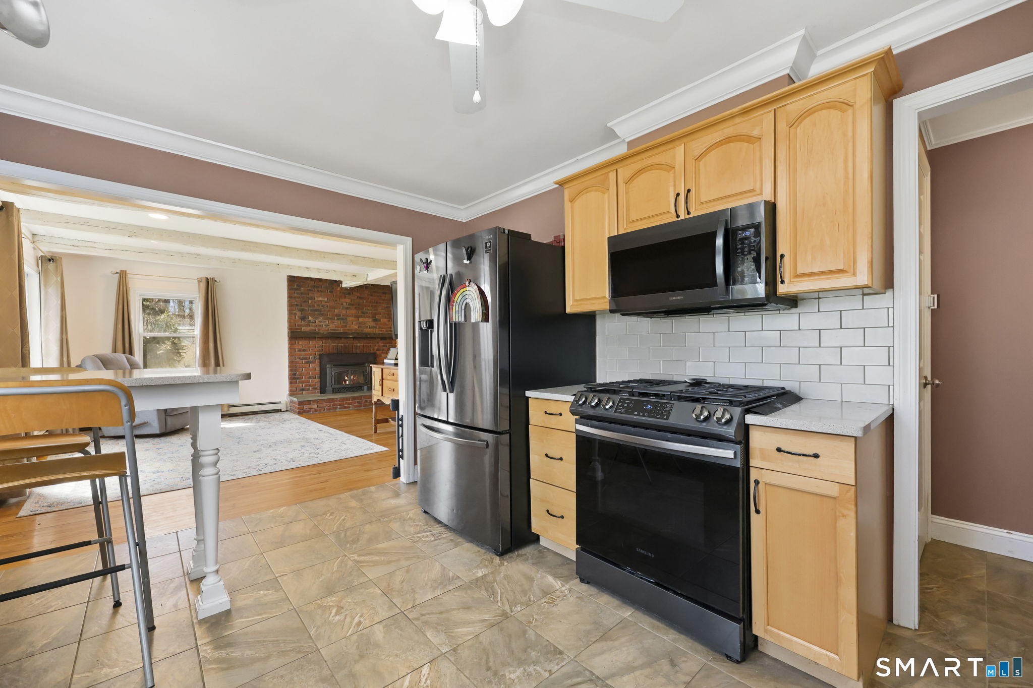 27 Lanesville Road New Milford, CT 06776 - Photo 17 of 38 a kitchen with stainless steel appliances granite countertop a stove top oven a sink dishwasher a dining table and chairs with wooden floor