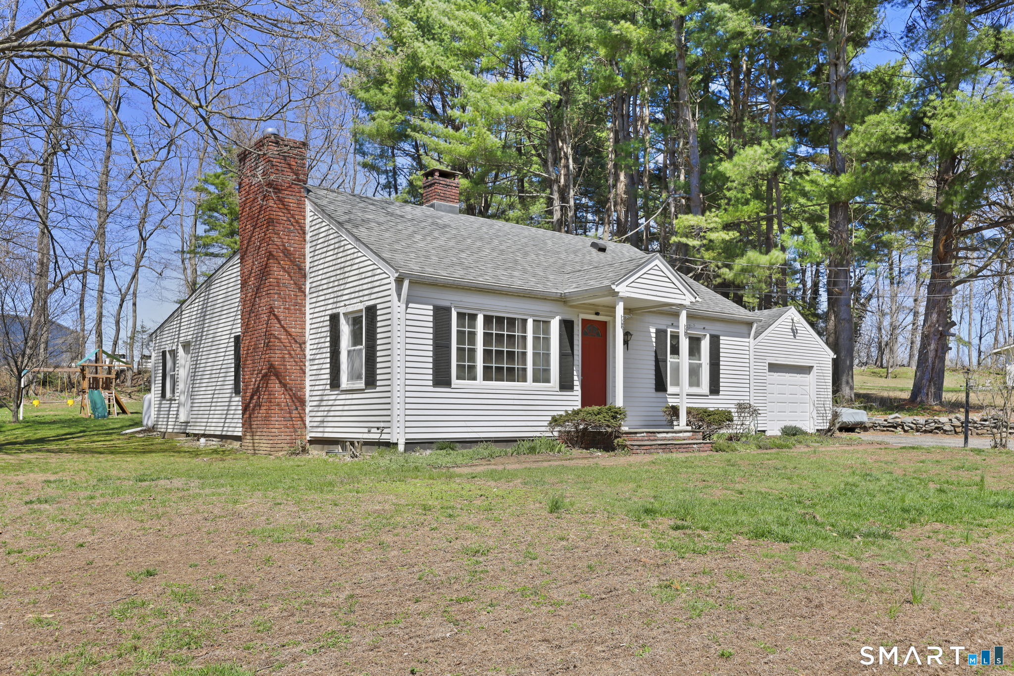 27 Lanesville Road New Milford, CT 06776 - Photo 2 of 38 a front view of a house with a garden and trees