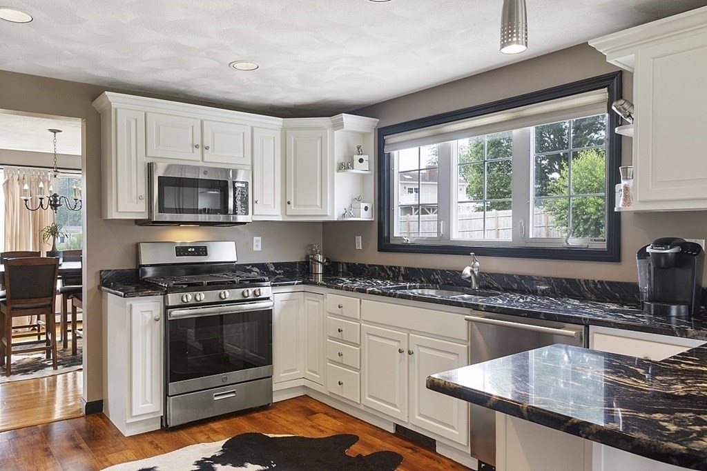 6 Violet Road Billerica, MA 01821 - Photo 11 of 42 a kitchen with granite countertop a sink stainless steel appliances and window