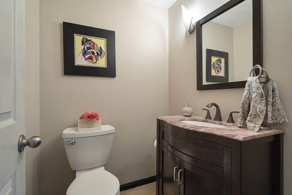 6 Violet Road Billerica, MA 01821 - Photo 15 of 42 a bathroom with a toilet a sink and mirror