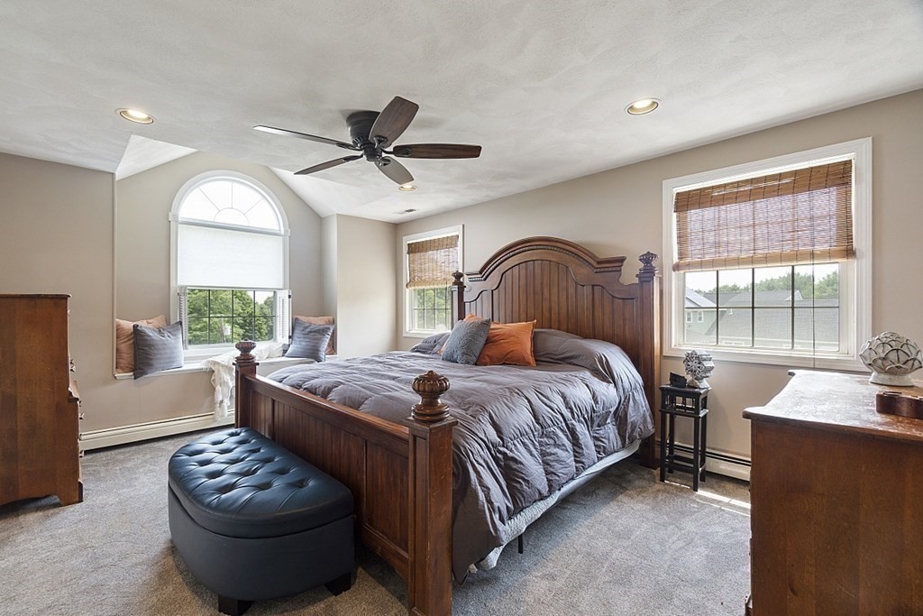 6 Violet Road Billerica, MA 01821 - Photo 19 of 42 a bedroom with a bed and a chandelier