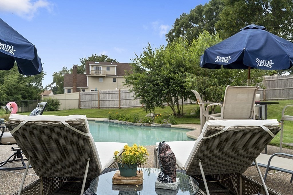 6 Violet Road Billerica, MA 01821 - Photo 36 of 42 a view of a chairs and table in patio with a lake view
