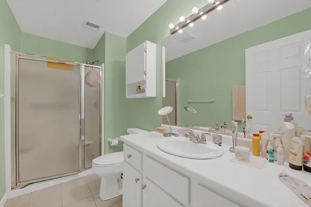a bathroom with a sink toilet vanity and shower