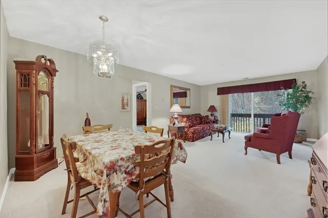 a view of a dining room with furniture wooden floor and a chandelier