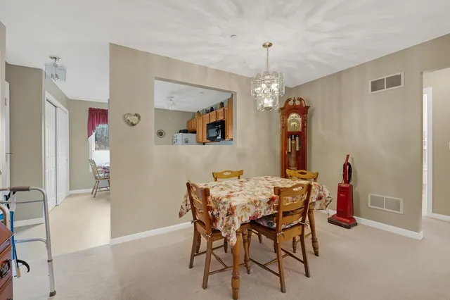 a view of a dining room with furniture and chandelier