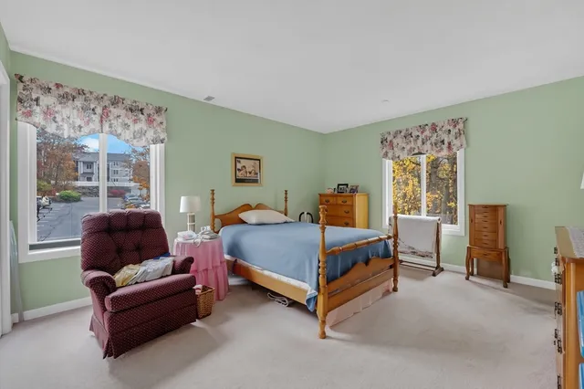 a bedroom with furniture and a large window
