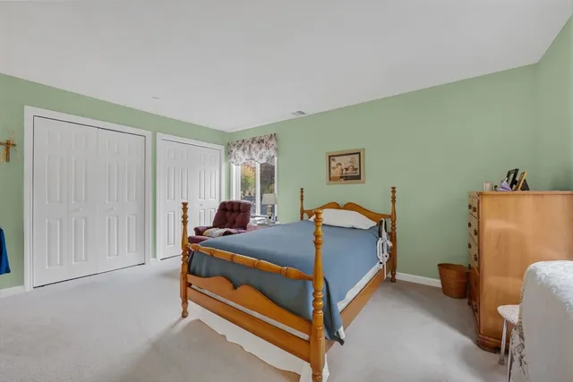 a bedroom with a bed and a table in it