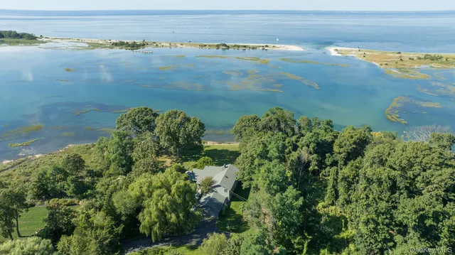 an aerial view of a houses with ocean view