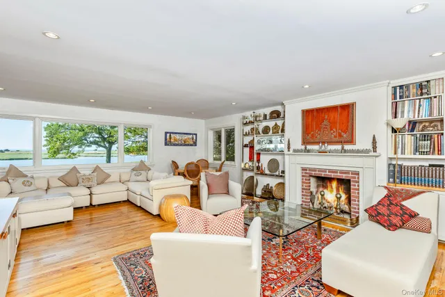 a living room with furniture fireplace and book shelf
