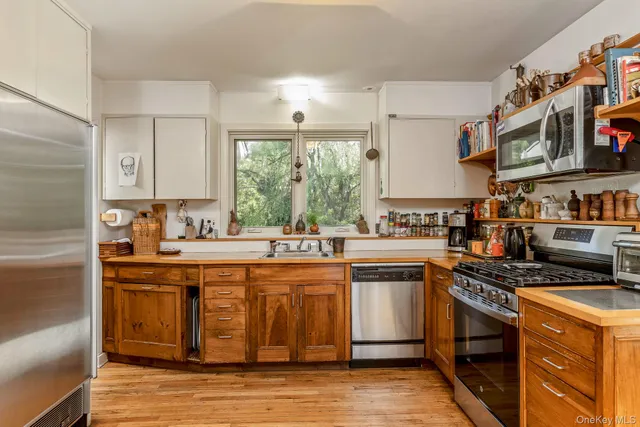 a kitchen with stainless steel appliances granite countertop a stove and a sink