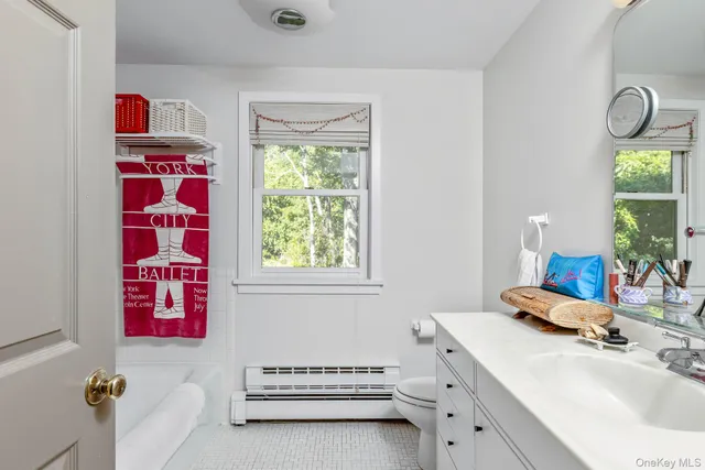 a en suite bathroom with a double vanity sink mirror and window